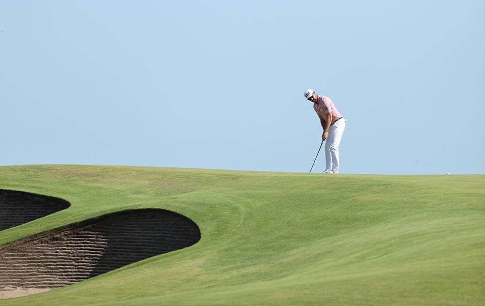 Corey Conners putting on a green